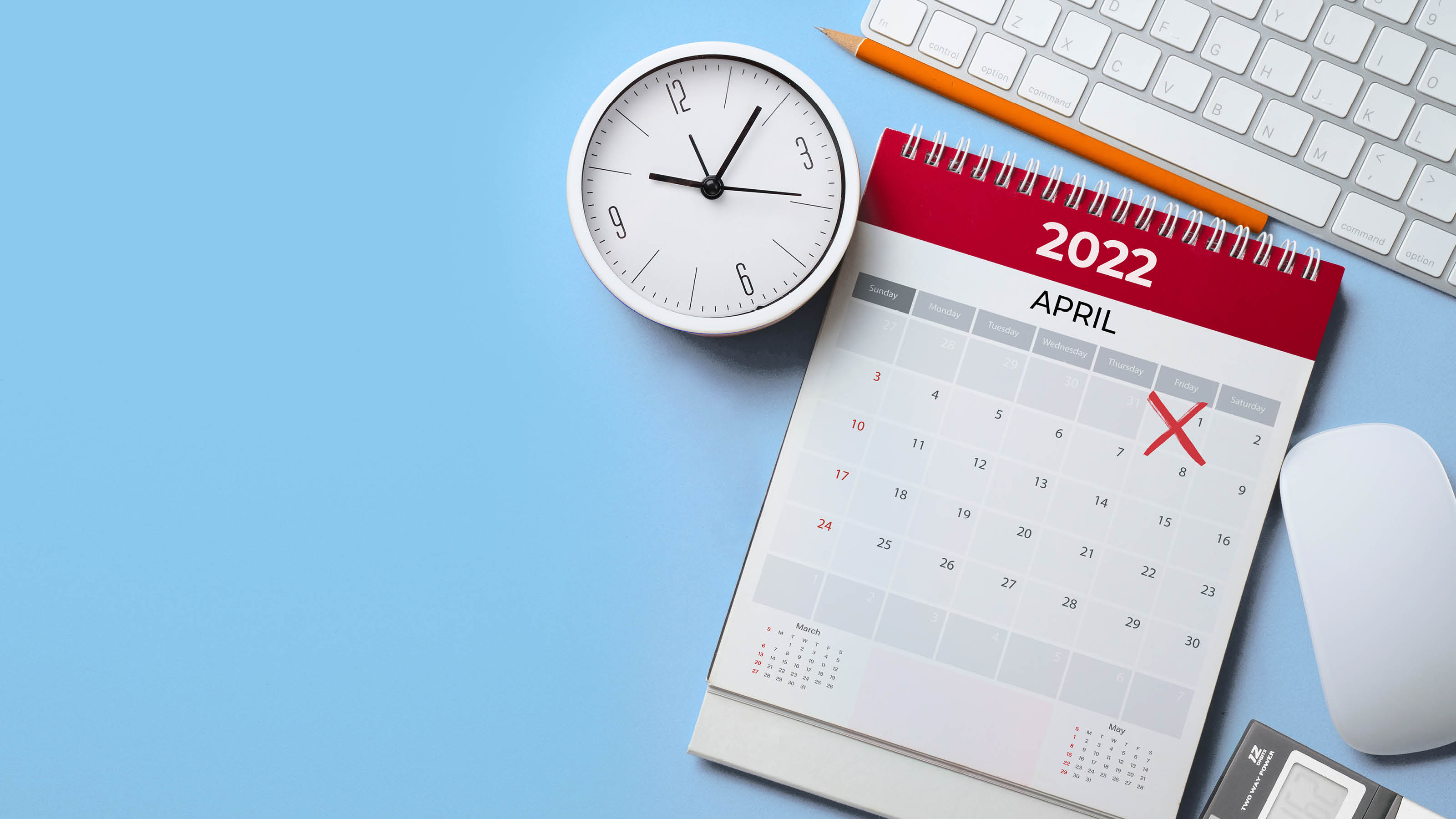 close up of calendar, alarm clock and accessories on the blue table background, planning for business meeting or travel planning concept