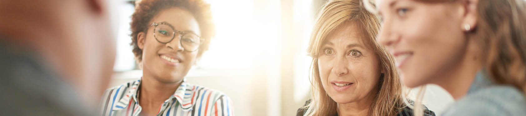 Unposed group of creative business people in an open concept office brainstorming their next project.