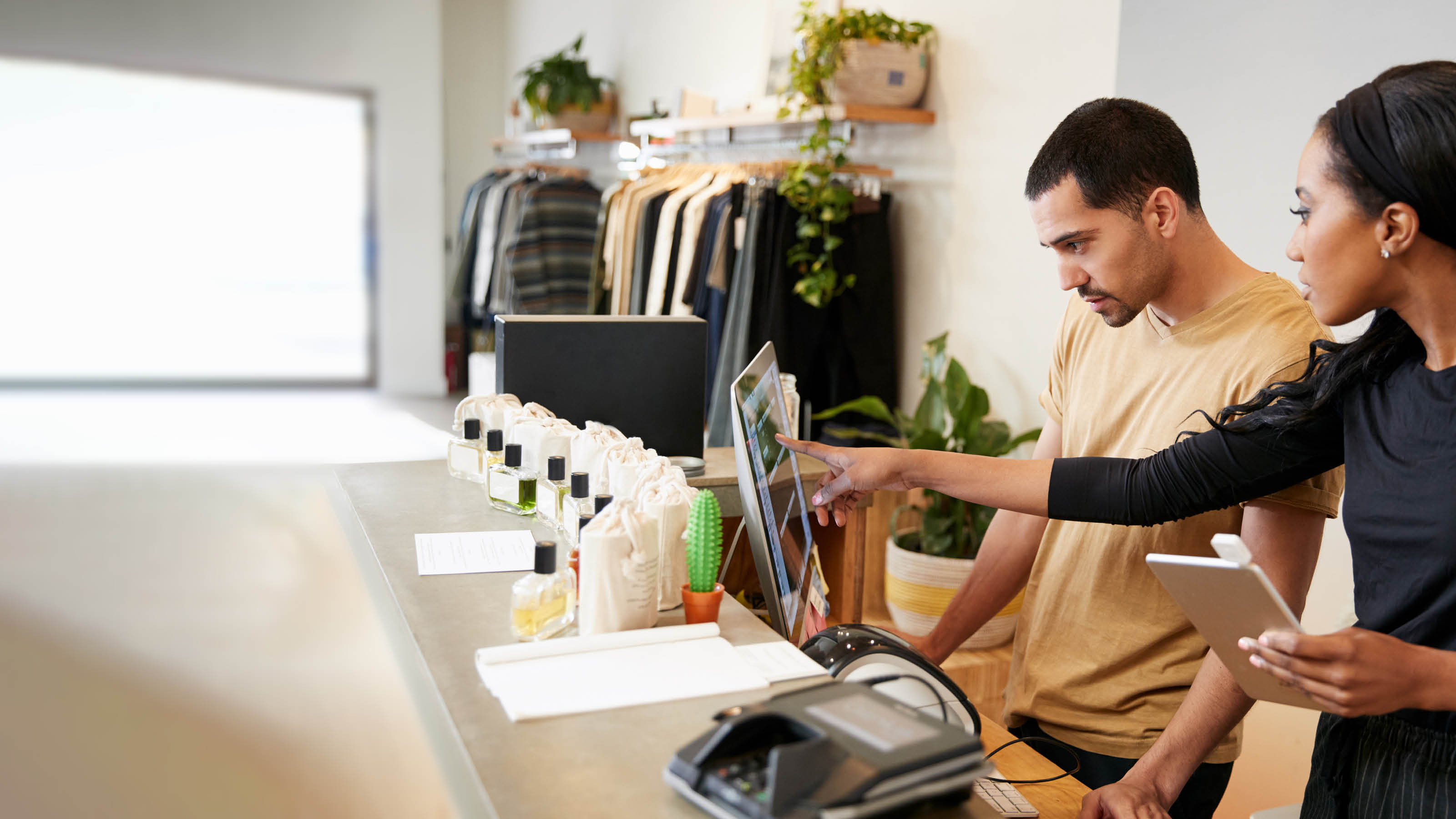 Man and woman working behind the counter in a clothing store