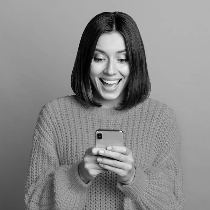 Portrait of attractive cheerful amazed girl using device gadget app smm post isolated over bright green color background