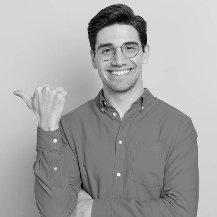 Portrait of attractive glad cheerful man manager demonstrating ad copy space isolated over grey color background