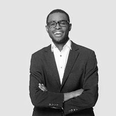 Happy african american young businessman in formal suit wearing eyeglasses portrait. Smiling millennial confident black guy posing for photo, looking at camera, isolated on grey studio background.