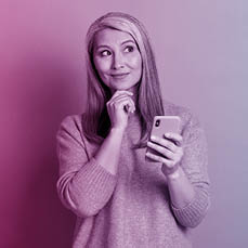 Photo of minded old woman use smartphone look copyspace touch fingers chin think thoughts decide texting typing chatting wear style stylish sweater isolated blue color background