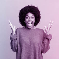 afro black woman feeling happy, excited, surprised or shocked, smiling and astonished at something unbelievable
