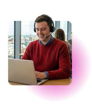 Managed Services representative sat in front of laptop with headset on