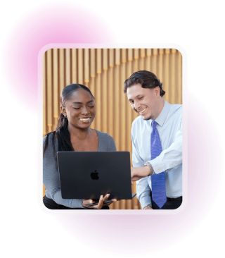 Two people looking at a laptop