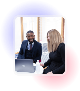 Two people looking at a laptop