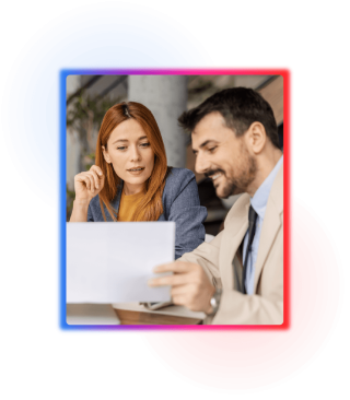 Business man showing a female coworker something of interest on a piece of paper