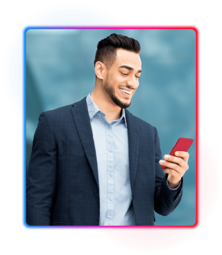 Young man in suit looking at phone and smiling