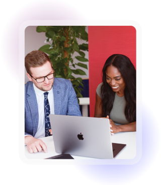 Two colleagues one male and one female sat in front of a laptop engaging with what is on screen