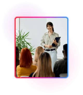Female trainer stood in front of a class of course attendees