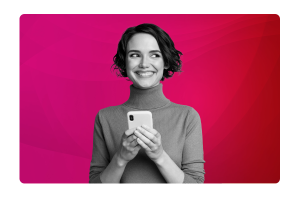 A lady smiling looking to the side, holding a mobile phone.