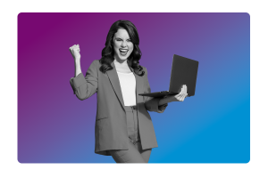 A lady with her fist up, smiling, holding a laptop in the other hand.