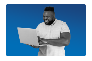 Man smiling at his laptop screen because his payroll has been outsourced correctly and in line with legislation compliance.