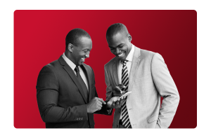 Two men in suits, smiling looking at a phone. remotely clocking into work with People Firsts workforce management functionalities.