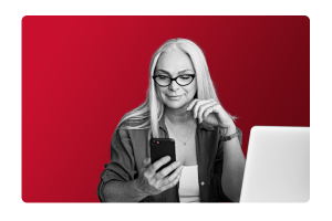 A lady with glasses looking pleased at her mobile phone after streamlining processes with People First's HR and Payroll software.