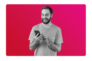 A man smiling looking at a mobile, happy after transforming internal processes with MHR's HR software People First.