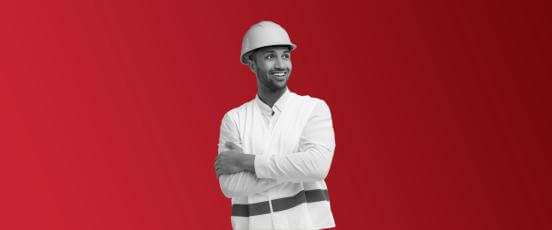 Man with hard hat on, smiling with crossed arms.