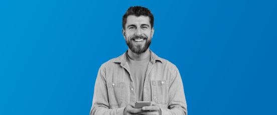 a man on his phone smiling