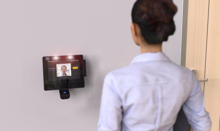 Woman clocking in with facial recognition