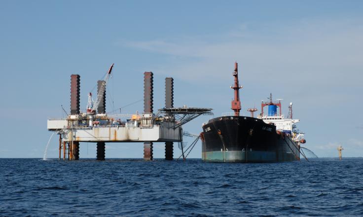 An oil rig and boat owned by Perenco pictured in the ocean