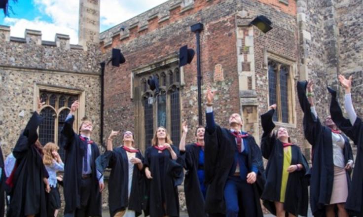 University graduates throwing their caps in the air.