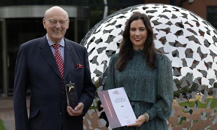 Mr John Mills and Ms Jessica Mills in front of the MHR head office holding the CIPP Software Product of the Year 2023 award. 