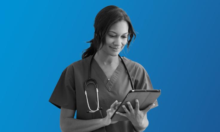 a doctor holding an ipad, managing the team through MHR's people first talent management software for healthcare.