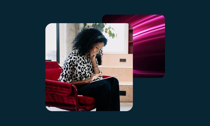 A lady sat, looking at a tablet.