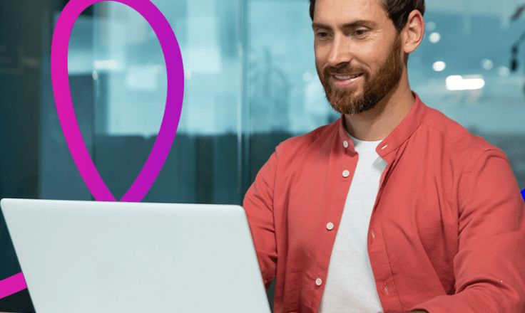 Image of a man working on a laptop. 