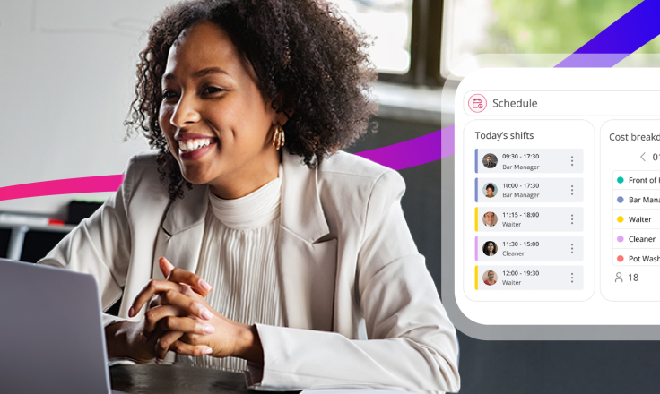woman smiling at laptop screen whilst looking at a workforce management scheduling software