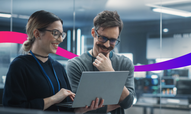 two people looking at a laptop