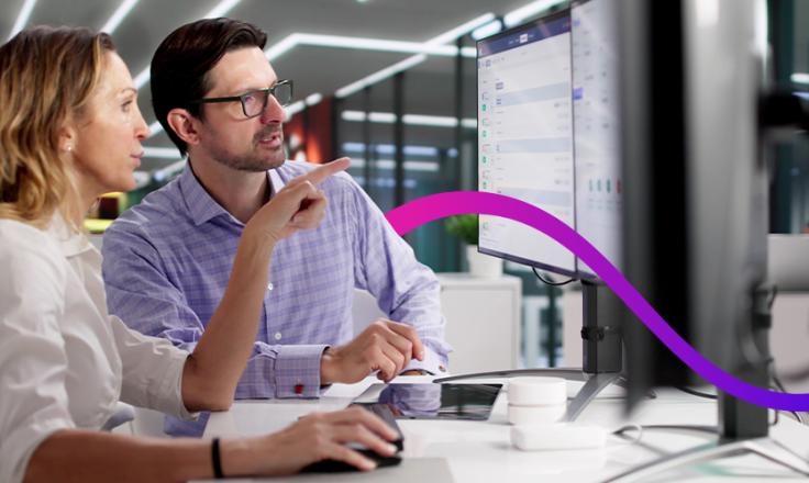 Man and woman looking at computer having a conversation