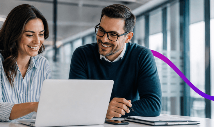 two people looking at a laptop