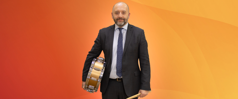 Anton Roe, MHR's Chief Executive Officer, holding drum sticks and a snare drum