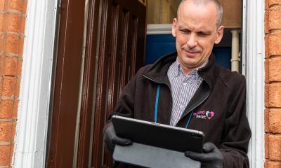 Man using tablet on his doorstep