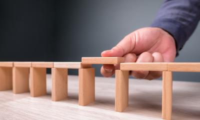 Wooden blocks with a gap in the middle, representing skills gaps in organisations