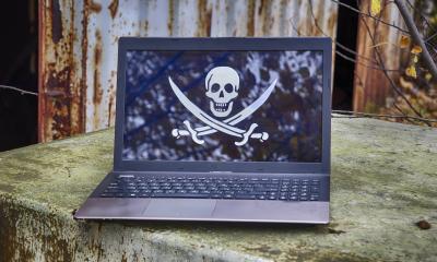 Skull and crossbones pictured on a laptop, representing data piracy