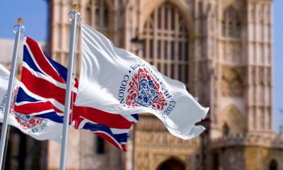 The Union Flag and Coronation logo flying near Westminster Abbey to celebrate the coronation of King Charles