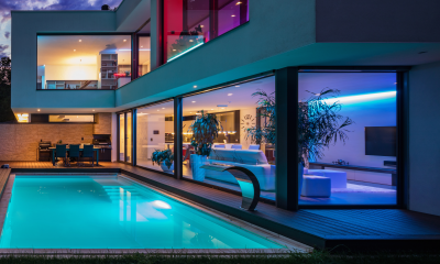 Colourful night scene of house and pool