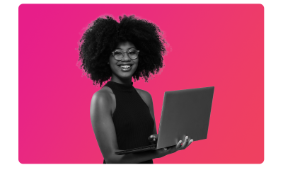 A lady with glasses on smiling holding a laptop, looking at vital insights MHR's analytics integration gives them.