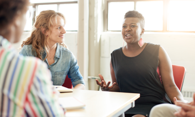 Three people talking at table