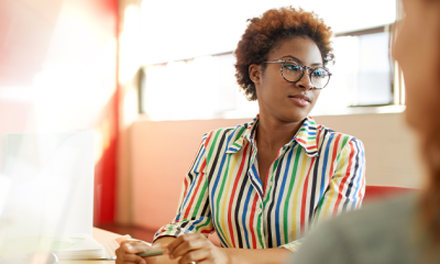 woman in stripy shirt wearing glasses