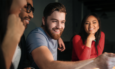 Four people sat on a table, smiling.