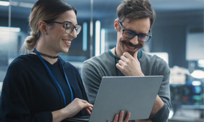 Two people with laptop smiling