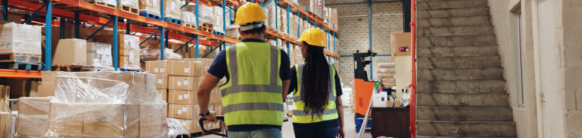 Two transport and logistics workers in the warehouse