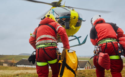 Emergency rescue workers in the field making their way to a helicopter