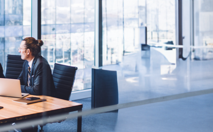 a group of people sat at a conference table in an office.