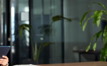 A lady working on a tablet in the office.