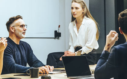 A group of people having a discussion in an office.